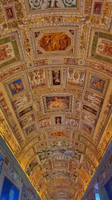 a ceiling with paintings on the ceilings of a building at Pop Corn Vatican Suites in Rome