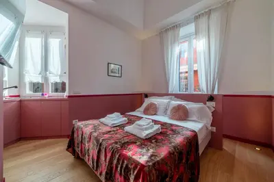 a bedroom with a bed with towels on it at Vatican Night Suites in Rome