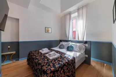 a bedroom with a bed and a window at Vatican Night Suites in Rome