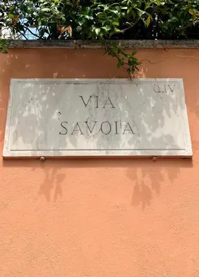a sign on a wall that says virgin savona at Savoia House, modern apartment near Villa Borghese in Rome