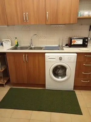 a kitchen with a washing machine and a sink at House Vaticano in Rome