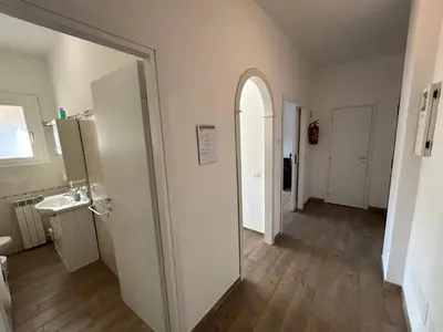 a room with a hallway with a sink and a refrigerator at CASA LINO in Rome