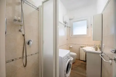 a bathroom with a toilet sink and a shower at CASA LINO in Rome