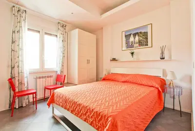 a bedroom with a bed and two red chairs at [Roma centro Storico * * * * *]- Via Torino Suite in Rome