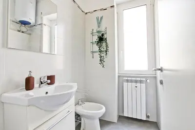 a white bathroom with a sink and a toilet at [Roma centro Storico * * * * *]- Via Torino Suite in Rome