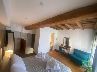a living room with a blue couch and a mirror at Margutta Domitia Home in Rome