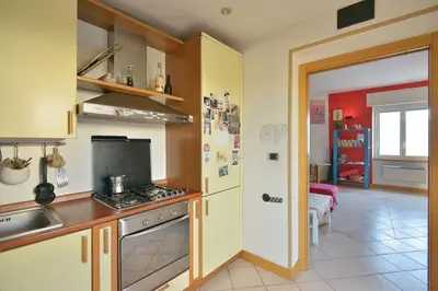 a kitchen with a sink and a stove top oven at SUPER SUNNY PENTHOUSE WITH TERRACE in Rome