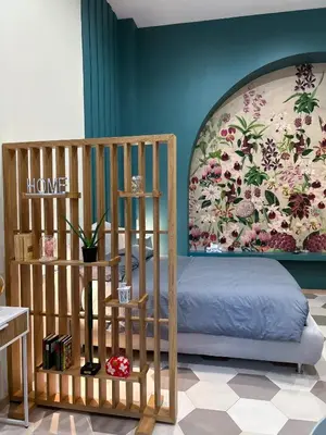 a bedroom with a bed and a floral wall at LOFT 125 passi dal Colosseo in Rome