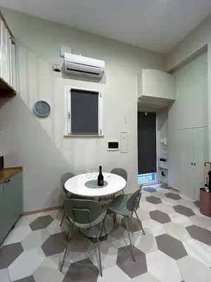 a kitchen with a table and chairs in a room at LOFT 125 passi dal Colosseo in Rome