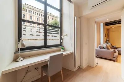 a room with a desk and a window with a chair at Luxury Loft next to Via Veneto in Rome