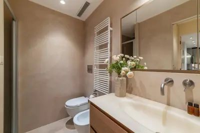 a bathroom with a sink and a toilet and a mirror at Luxury Loft next to Via Veneto in Rome