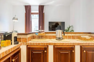 a kitchen with a counter with a sink and a microwave at Attico Campo de Fiori Katia in Rome