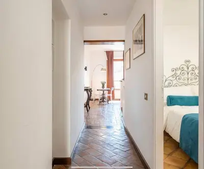 a hallway with a bed and a table in a room at Attico Campo de Fiori Katia in Rome