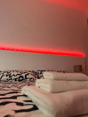 a room with a bed with a red light at Dolce Vita Rooms Monteverde Trastevere in Rome