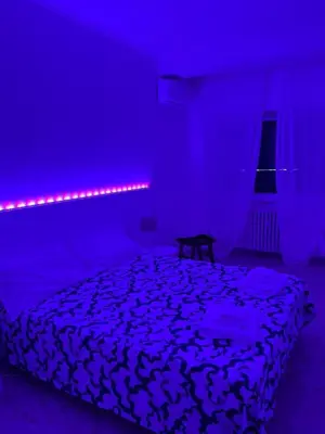 a bedroom with a bed with a purple light at Dolce Vita Rooms Monteverde Trastevere in Rome