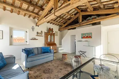 a living room with a blue couch and a table at Casa Adriana, a Burghesius home in Rome