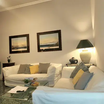 a living room with two white couches and a lamp at Vatican Stairs Apartment in Rome