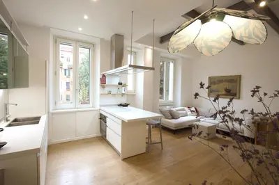 a kitchen and living room with a table and a couch at Magnolia House in Testaccio in Rome