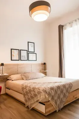 a bedroom with a bed and a large window at Re di Roma apartment in Rome