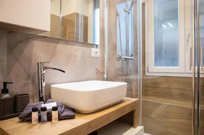 a bathroom with a white sink and a shower at Re di Roma apartment in Rome