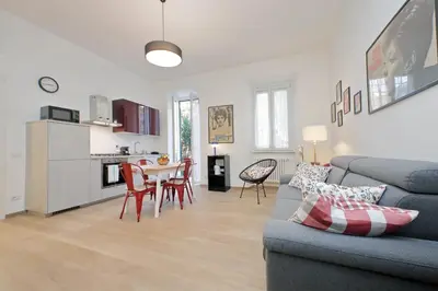 a living room with a couch and a table with chairs at YCH-Brand new Vatican flat with terrace in Rome