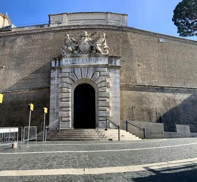 a large brick building with stairs leading to a doorway at Mate's Apartment in Rome