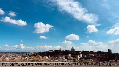 a view of a city under a blue sky with clouds at Mate's Apartment in Rome