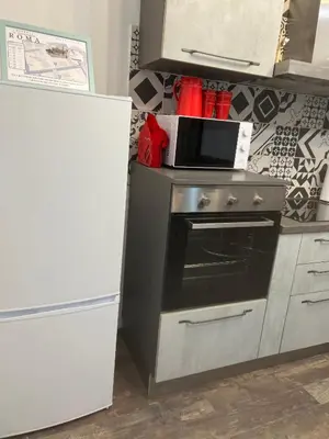 a kitchen with a microwave on top of a stove at Casa Bravetta - Parking Private in Rome