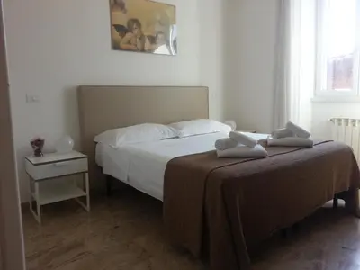 a bedroom with two beds with towels on them at Between Termini & Colosseo in Rome