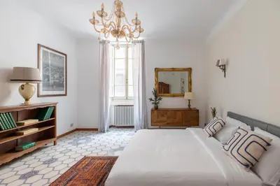 a white bedroom with a large bed and a mirror at iFlat Barberini 's Dream in Rome