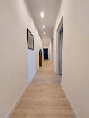 a hallway with white walls and a wooden floor at Galleria del Principe in Rome