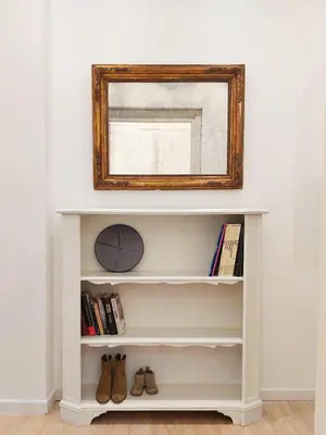 a shelf with a clock and a mirror at Galleria del Principe in Rome