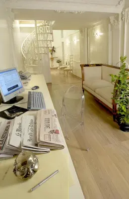 a living room with a desk with a computer and a couch at Suites Rome in Rome