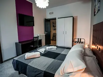 a bedroom with a large bed with two pillows on it at Casa Celestina Roma in Rome