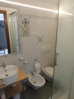 a bathroom with a sink and a toilet and a mirror at Madonna della Neve in Rome