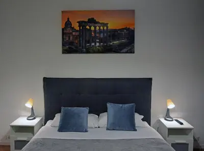 a bedroom with a large bed with two nightstands and two lamps at La maison de Rome Vatican Apart in Rome