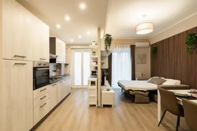 a kitchen and living room with a bed and a room at Albadomus Apartment in Rome