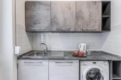 a kitchen with a sink and a washing machine at INN3 APT in Rome