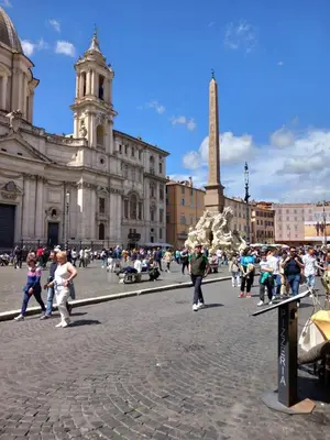 a crowd of people walking in a plaza in front of a building at Navona 68 in Rome
