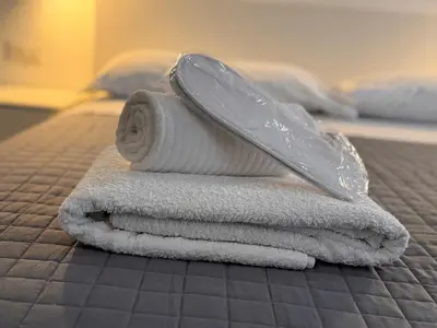 a pile of towels on a bed with a knife at Navona 68 in Rome