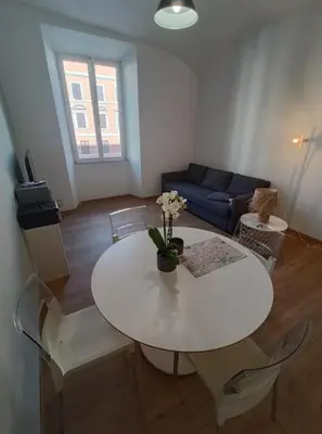 a living room with a white table and chairs at Casa Filiberto in Rome