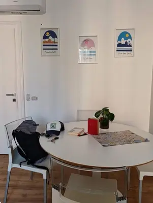 a white table with two chairs and a table with a plant at Casa Filiberto in Rome