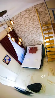an attic room with a bed and a staircase at RESIDENZA ROSA in Rome