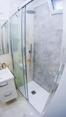 a shower with a glass door in a bathroom at RESIDENZA ROSA in Rome
