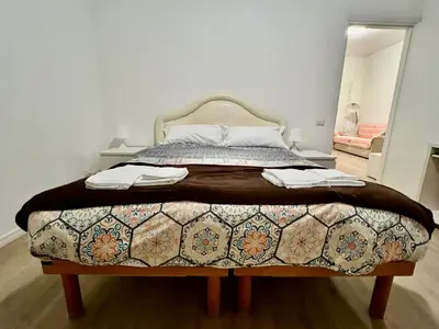 a bedroom with a large bed with a blanket at Domus Antonia in Rome