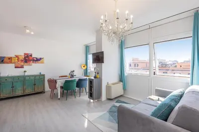 a living room with a table and a chandelier at Laterano View by Rental in Rome in Rome