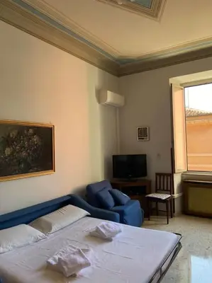 a room with a bed and a couch and a tv at Apartment Rome Vatican in Rome