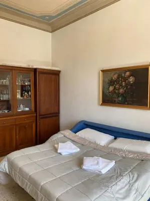 a bedroom with a bed and a painting on the wall at Apartment Rome Vatican in Rome
