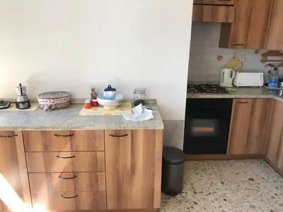 a kitchen with wooden cabinets and a counter top at Apartment Rome Vatican in Rome