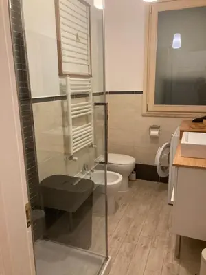 a bathroom with a glass shower and a toilet at 8380 Lory's House in Rome